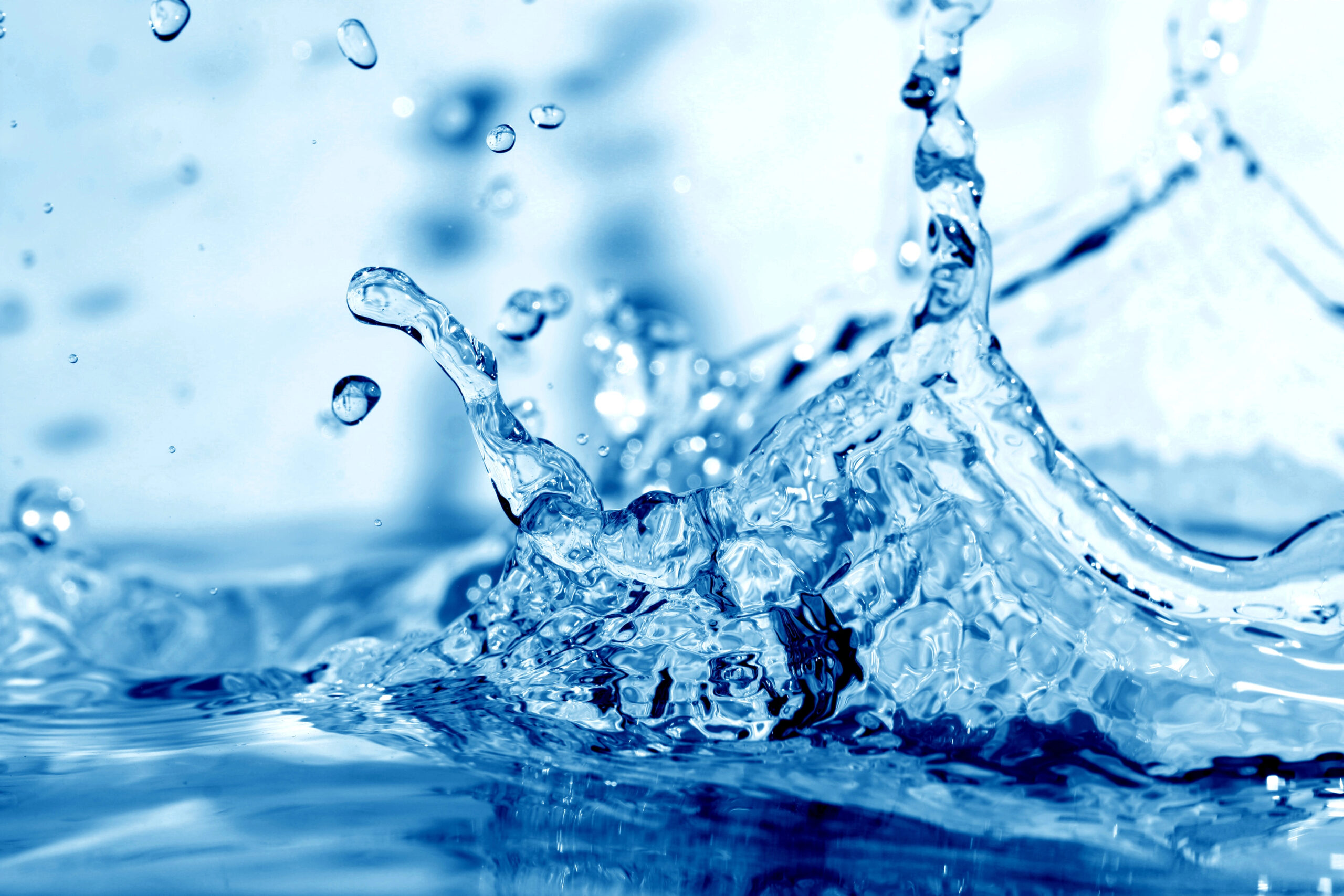 Close-up splash of clear blue water showing droplets and movement
